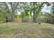 Spacious backyard with mature trees and a wood fence at 1920 30Th E Ave, Bradenton, FL 34208