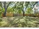 Large fenced backyard with mature trees and green space at 1920 30Th E Ave, Bradenton, FL 34208