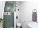 Modern bathroom features a stylish walk-in shower with eye-catching green tiling and recessed shelving at 1920 30Th E Ave, Bradenton, FL 34208