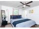 Well-lit bedroom with a ceiling fan, neutral decor, and a comfortable bed with stylish blue pillows and throw at 1920 30Th E Ave, Bradenton, FL 34208