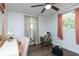 Bright bedroom with ceiling fan, wood-look floors, and light-filled windows at 1920 30Th E Ave, Bradenton, FL 34208