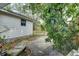 Exterior home detail with lush tropical landscaping and patio at 1920 30Th E Ave, Bradenton, FL 34208