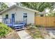 Charming home exterior with blue porch and well-manicured landscaping at 1920 30Th E Ave, Bradenton, FL 34208