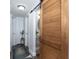 Hallway featuring a large wooden sliding door and natural lighting at 1920 30Th E Ave, Bradenton, FL 34208
