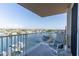 Balcony view with a chair overlooking a peaceful waterfront and cityscape at 223 Island Way # 5E, Clearwater Beach, FL 33767