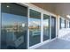 Waterfront home featuring a balcony and sliding glass doors overlooking the city at 223 Island Way # 5E, Clearwater Beach, FL 33767
