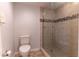 Clean bathroom featuring a glass-enclosed shower, toilet, neutral tile, and ample space for relaxation at 223 Island Way # 5E, Clearwater Beach, FL 33767