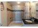 Bathroom featuring a shower-tub combination, tiled walls, and a modern vanity at 223 Island Way # 5E, Clearwater Beach, FL 33767