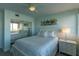 Light-filled bedroom with mirrored closet doors, pastel decor, and a view of the waterfront at 223 Island Way # 5E, Clearwater Beach, FL 33767
