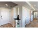 Hallway featuring extra storage, coat closet, and views into the kitchen and bedroom areas at 223 Island Way # 5E, Clearwater Beach, FL 33767