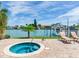 Relaxing outdoor hot tub with waterfront views and nearby lounge chairs at 223 Island Way # 5E, Clearwater Beach, FL 33767