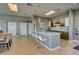 Modern kitchen boasts an island with seating, sleek countertops, stainless steel appliances, and decorative tile backsplash at 223 Island Way # 5E, Clearwater Beach, FL 33767