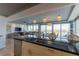 Open kitchen with granite counters, stainless appliances, pendant lighting and scenic water views at 223 Island Way # 5E, Clearwater Beach, FL 33767