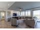 Spacious living room with neutral tones, a ceiling fan, and large windows offering scenic views at 223 Island Way # 5E, Clearwater Beach, FL 33767