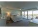 Bright main bedroom features balcony access and an en-suite bath at 223 Island Way # 5E, Clearwater Beach, FL 33767