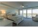 Inviting main bedroom with balcony access and neutral-toned decor at 223 Island Way # 5E, Clearwater Beach, FL 33767