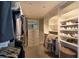 Bright walk-in closet featuring custom white shelving, built-in drawers, and hanging rods for maximum storage at 223 Island Way # 5E, Clearwater Beach, FL 33767