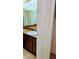Bathroom vanity area featuring bright lighting and tile flooring, with access to the closet area at 23059 Geneva Rd, Land O Lakes, FL 34639