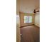 Bedroom featuring neutral carpet, a ceiling fan, a window, and a closet at 23059 Geneva Rd, Land O Lakes, FL 34639