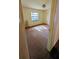 Bedroom with carpet flooring, a double door closet and a window providing natural light at 23059 Geneva Rd, Land O Lakes, FL 34639