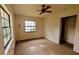 Bedroom with a ceiling fan, carpet, and two large windows at 23059 Geneva Rd, Land O Lakes, FL 34639