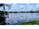 Lake reflects the cloudy sky in this backyard view from the property at 23059 Geneva Rd, Land O Lakes, FL 34639