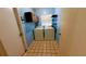 Cozy laundry room featuring a washer, a dryer, tile flooring and shelving at 23059 Geneva Rd, Land O Lakes, FL 34639