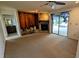 Carpeted living room with fireplace and sliding glass doors to the pool at 23059 Geneva Rd, Land O Lakes, FL 34639
