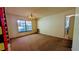 Open-concept living space featuring broad window and chandelier; adjacent entryway visible at 23059 Geneva Rd, Land O Lakes, FL 34639