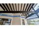 The covered patio with dark wooden beams and unique decorative blue trim at 23059 Geneva Rd, Land O Lakes, FL 34639