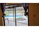 The outdoor patio features a hot tub and pool, with views of the lake through the screen at 23059 Geneva Rd, Land O Lakes, FL 34639