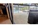 An outdoor pool is surrounded by a screened lanai, with a lake view and stone fireplace at 23059 Geneva Rd, Land O Lakes, FL 34639