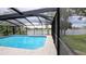 Enjoy the pool in a screened enclosure overlooking the serene lake at 23059 Geneva Rd, Land O Lakes, FL 34639