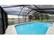 The pool has a screened lanai and the backyard looks out onto a lake at 23059 Geneva Rd, Land O Lakes, FL 34639