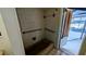 A dark brown shower area next to a door, partially revealing an outdoor pool area at 23059 Geneva Rd, Land O Lakes, FL 34639