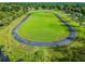 Aerial view of running track surrounded by lush green field at 23059 Geneva Rd, Land O Lakes, FL 34639