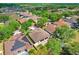 Aerial view of the property with a brown roof surrounded by lush landscaping at 2605 Durant Trails Blvd, Dover, FL 33527