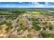 An aerial neighborhood view featuring a home with mature trees and landscaping in a quiet neighborhood at 2605 Durant Trails Blvd, Dover, FL 33527