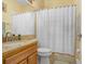 Bathroom with vanity, toilet, and a shower/tub combination with a curtain at 2605 Durant Trails Blvd, Dover, FL 33527