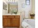 This bathroom includes a soaking tub with tile surround and a wood vanity at 2605 Durant Trails Blvd, Dover, FL 33527