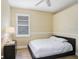 This bedroom offers a queen size bed, wood floors and a neutral color palette at 2605 Durant Trails Blvd, Dover, FL 33527