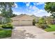 Attractive single-Gathering home with a neatly manicured lawn, three-car garage, and serene surroundings at 2605 Durant Trails Blvd, Dover, FL 33527