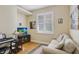 Cozy living room with comfortable seating and a bright window with plantation shutters at 2605 Durant Trails Blvd, Dover, FL 33527