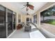 Neutral sunroom featuring comfortable seating, a ceiling fan, and seamless access to the outdoors at 2605 Durant Trails Blvd, Dover, FL 33527