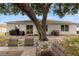 Backyard showcasing an entertaining space with mature tree, seating and sliding glass doors at 3011 49Th S Ter, St Petersburg, FL 33712