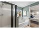 Bathroom with a soaking tub, framed shower, and doorway view to the main bedroom at 3011 49Th S Ter, St Petersburg, FL 33712