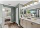 Well-lit bathroom featuring a double vanity with marble counters and views into the bedroom at 3011 49Th S Ter, St Petersburg, FL 33712