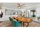 Elegant dining room with a wooden table, stylish chairs, and a modern ceiling fan at 3011 49Th S Ter, St Petersburg, FL 33712