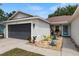 Single-story home with landscaped front yard and a blue front door providing an inviting touch at 3011 49Th S Ter, St Petersburg, FL 33712