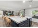 Stylish kitchen island featuring seating, white countertops, navy cabinets and a view to the living area at 3011 49Th S Ter, St Petersburg, FL 33712